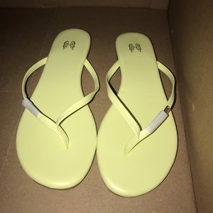 Neon yellow flip flops